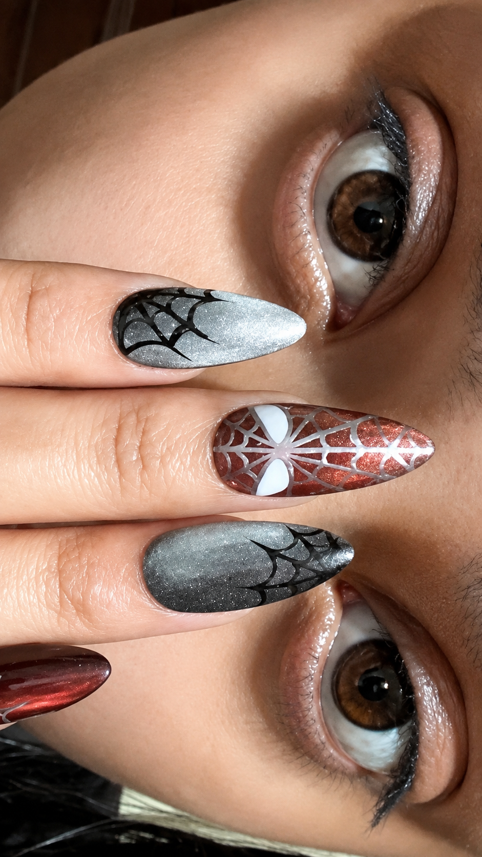 Custom handmade press-on set with hand-painted web detailing in red, silver and black, created for a client's movie night